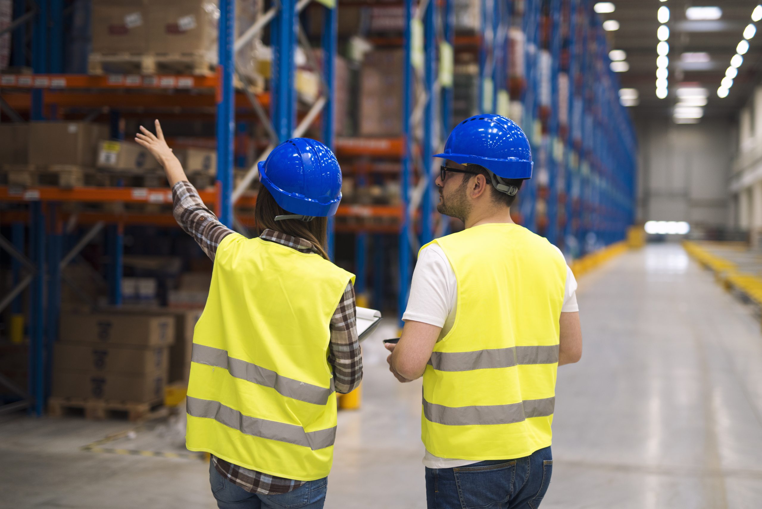 two warehouse personnel carrying out inventory checks